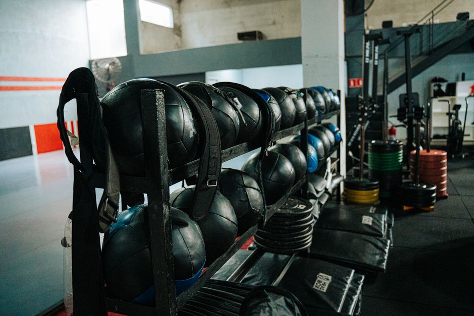 Well-equipped indoor gym featuring kettlebells, weights, and workout gear
